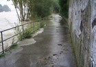überschwemmter Weg, links die Donau und rechts die Mauer eines Gebäudes